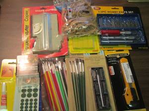 lot 705 image: small paint bruhes, rubber bands, ezecto knife, new pack of blades and more