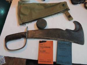 lot 663 image: Woodsman pal - 280 victor tool co. pa, blade length 11 34 width  end of blade 5, 16 12 long in canvas sheath with whet stone