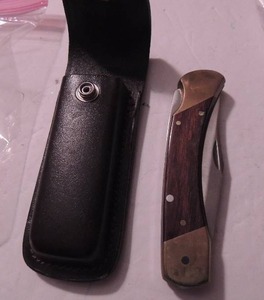 lot 131 image: Schrade - lb7 - uncle henry bear paw lockback 3 34 b.l , 5 closed 8 34 long leather belt sheath