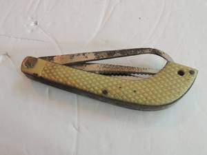 lot 610 image: fishing knife labeled spi 3242 5 length, 3 14 blade, saw, hook bottle opener