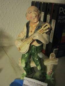lot 1580 image: man playing guitar figurine