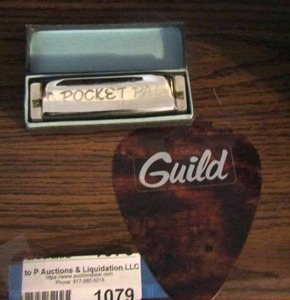 lot 1079 image: pocket harmonica - large guitar pic