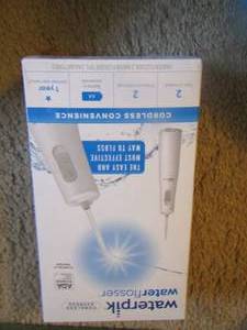 lot 1124 image: NIB cordless water pic flosser