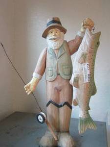lot 1234 image: wooden fisher man holding a fish statue