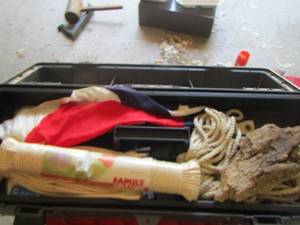 lot 1953 image: large tool box full of ropes, American flag, caulking guns and more