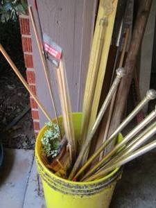 lot 1955 image: yellow bucket of curtain rods
