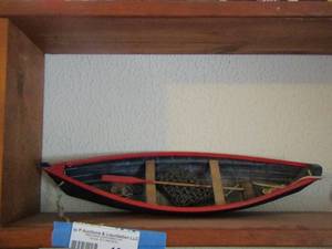 lot 1046 image: wooden boat red and black