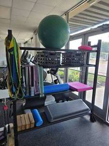 lot 15 image: Metal Gym Rack w Lots of Equipment Included.  Includes Yoga Ball, Stretch Bands, Rollers, Step Platform & More.  Shelf Measures 72 x 72 x 14