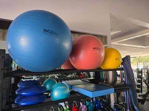 lot 88 image: Contents of Top 2 Shelves.  Includes 3 Thera Band Pro Series Yoga Balls, Bands, Straps & More