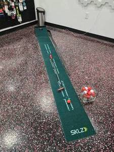 lot 161 image: Sklz Putting Mat w Putter & Glass Container Full of Golf Balls