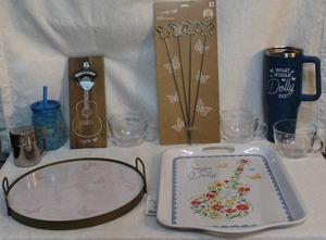 lot 97 image: Mixed lot of Dolly Parton things serving trays skewers bottle opener glasses and more see pictures
