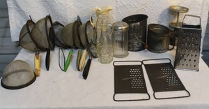 lot 17 image: vintage kitchen gadgets and tools.including a box grater and two flat graters,vintage Watkins Triple Flour Sifters. And much more