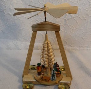 lot 133 image: German Christmas pyramid, also known as a Weihnachtspyramide. It is a traditional Christmas decoration from the Ore Mountain region of Germany.The pyramid is a wooden carousel with multiple tiers that are turned by the heat of lit candles.