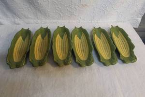 lot 286 image: corn on the cob plates, which are ceramic serving dishes shaped like an ear of corn.