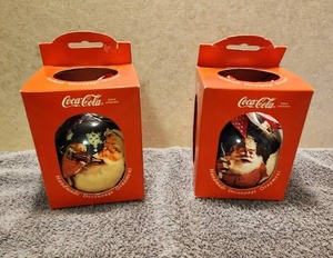 lot 85 image: Selection of 2 vintage 1993 Enesco Coca Cola handmade decoupage Christmas Ornaments