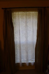 lot 69 image: Red and Beige Black out Curtains and White Lace Shear Curtain. Curtain Rod and hardware included with Metal tiebacks