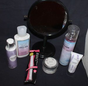 lot 88 image: Free Standing Mirror, Bath and Body works Lovely Dreamer Lotion and Body Spray, and Lavendar lotions and bath products. Wink of Stella Brush in Package