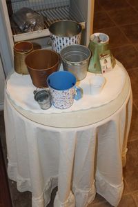 lot 186 image: Small Round Table with Glass Top and Contents of Top and Table Cloth
