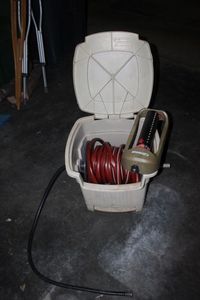 lot 296 image: Water Hose Holder with Hose and Sprinkler