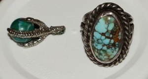 lot 22 image: Sterling silver ring and claw pendant. Rings stone appears cracked, initials are carved on setting. Claw marked 925 with green marble type stone.