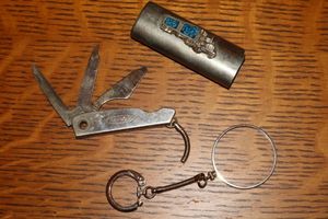 lot 25 image: Silver lighter cover with semi-truck, key ring and pocket knife