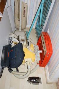 lot 60 image: Vintage Eureka vacuums, automatic floor robot cleaner (powers on but screen is blank), vintage Wards ironing board and vintage iron