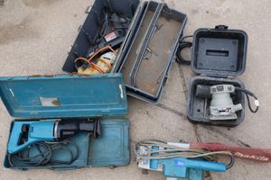lot 239 image: Tools Makita belt sander, Makita reciprocating saw, drills, and palm sander