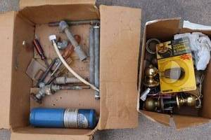 lot 234 image: Misc. door knobs, Misc. pipe pieces, screwdrivers, and propane cylinder