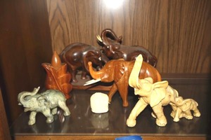 lot 109 image: Elephant carved figurines, one is signed A. Santini