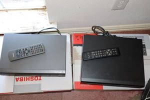 lot 103 image: Two VCR players with remotes