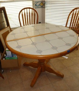 lot 82 image: Pedestal kitchen table (table only) with tile top as shown (bring tools to disassemble)
