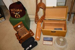 lot 183 image: MOSLAH felt cap (tag says Lloyd Smiths Moslah Fez), pipe holder box, leather sheath belt and more
