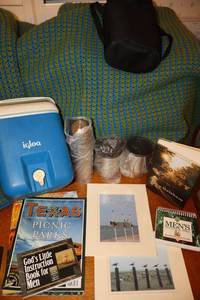 lot 197 image: Blue and green afghan, small cooler, travel thermos and mug set (looks new), books and photo prints