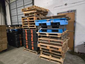 lot 62 image: MASSIVE LOT OF WOODEN & PLASTIC MOLDED PALLETS.  BUYER TAKES ALL