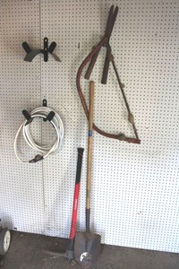 lot 85 image: Yard tools with pick axe and garden hose