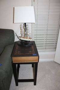 lot 57 image: Moby Dick book style side table (14x20x24) with sailboat lamp