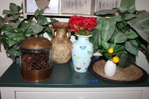 lot 97 image: Home dcor with copperglass jars with scented pine cones, vases, and artificial plants
