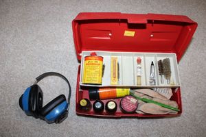 lot 42 image: Gun cleaning supplies with headgear