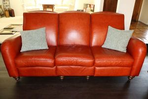 lot 48 image: Red leather sofa couch - 7ft. W x 38d x 39h. Both end seats recline and the cushions are Velcroed.
