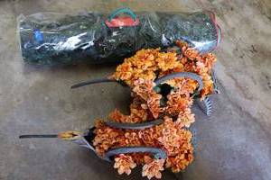 lot 206 image: Two hummingbird flower holders made from old tires and small Christmas tree