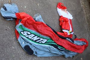 lot 209 image: Christmas fishing Santa inflatable with outdoor extension cord