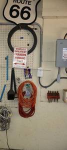 lot 176 image: Signs, drain snake, extension cords, Spade drill bit set, and grill scraper