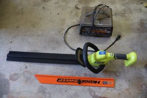 lot 181 image: Battery charger and Ryobi hedge trimmer (cordless but needs battery)