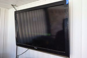 lot 66 image: Toshiba TV with remote. Powered on at time of photo.