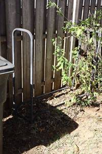 lot 218 image: Metal trash bin stand or Firewood rack