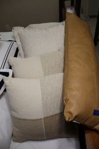 lot 127 image: Biege accent pillows and long leather style pillow