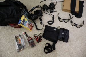 lot 112 image: TX Motor Speedway lot Track Scan headgear, Bushnell binoculars, solar sunglasses, ponchos and more