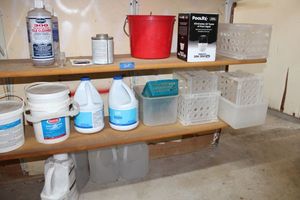 lot 205 image: Pool cleaners plus stabilizer, bleach, chemical float, tile cleaner, small storage bins
