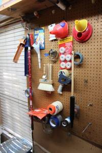 lot 196 image: Tape, caulking guns, paint rollers, Mosquito Dunks, funnels and pipe clamps