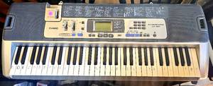 lot 10 image: Casio LK-100 Keyboard 61 Key - Lighted Key System - 100 Tones 50 Rhythms P33 (NEEDS POWER SUPPLY approx $15)